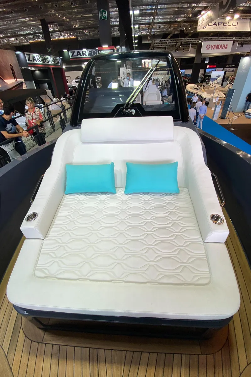 Slide: The Image of 2024 Zar Formenti Imagine 130 luxury boat with white seating and turquoise pillows. - 7