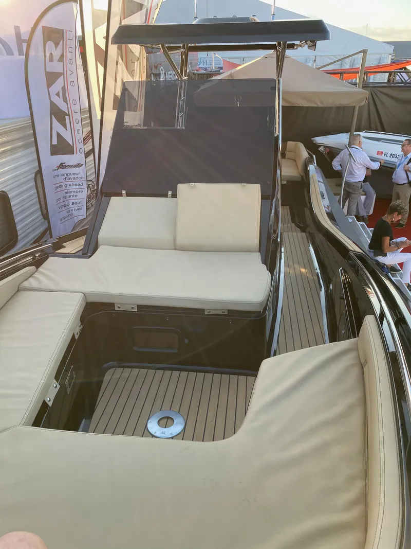 Slide: The Image of 2024 Zar Formenti 95SL luxury boat with spacious seating and sleek design at a boat show. - 7