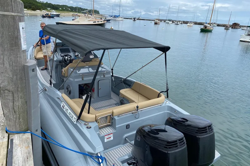 Slide: The Image of 2025 Zar Formenti 85 SL boat docked, featuring dual engines and a canopy. - 12