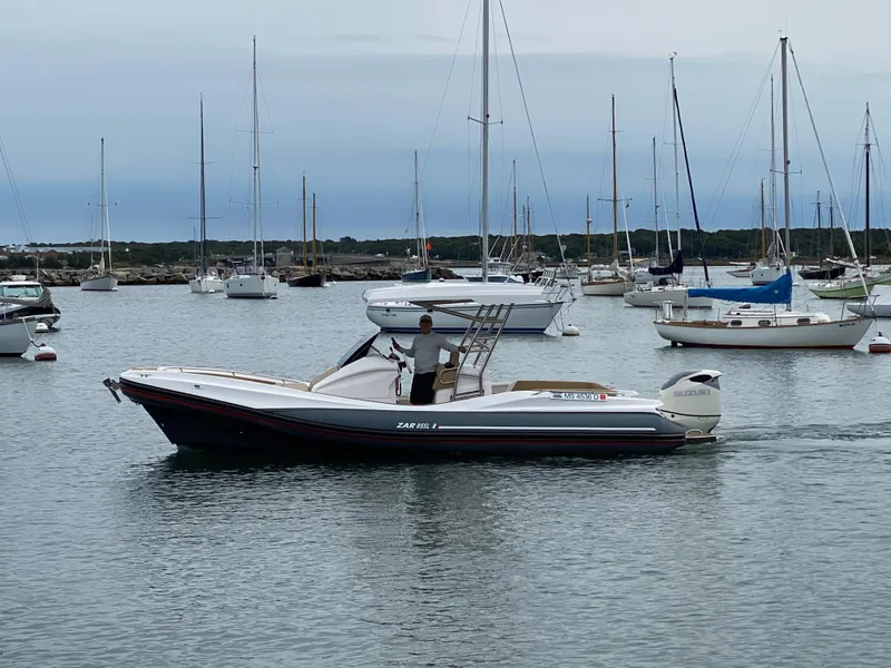 Slide: The Image of 2025 Zar Formenti 85 SL boat displayed at a marina with promotional banners. - 2