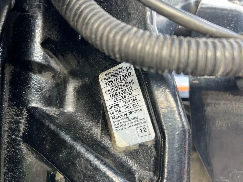 Slide: The Image of Close-up of a 1999 Triton TR20 engine label with specifications. - 12