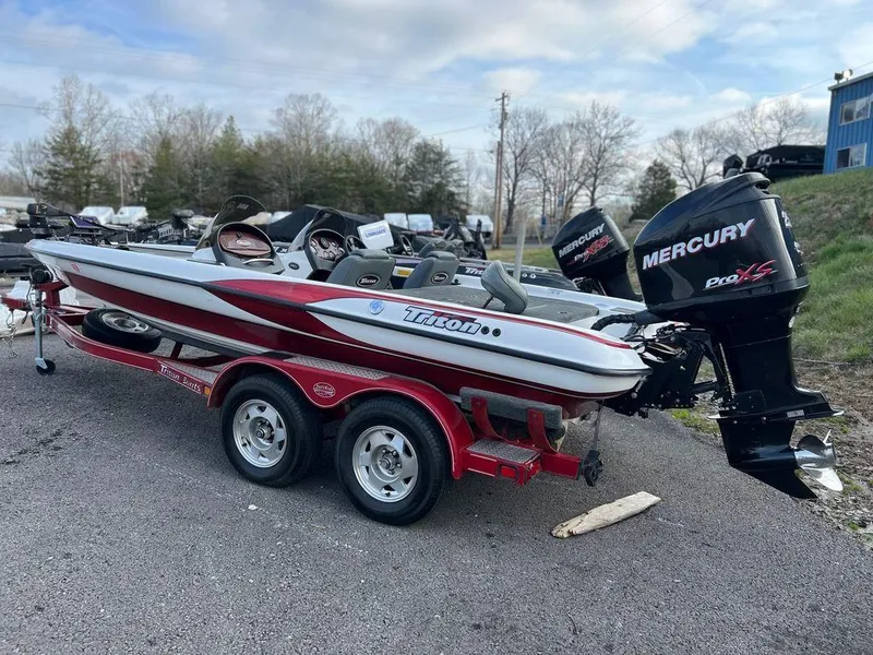 Slide: The Image of 1999 Triton TR20 boat with Mercury Pro XS engine on a trailer. - 3