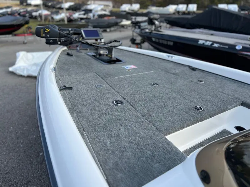 Slide: The Image of 1999 Triton TR20 boat deck with mounted equipment in a marina setting. - 8