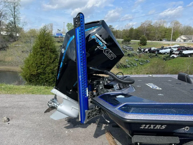 Slide: The Image of 2022 Bullet 21XRS boat with Mercury Pro XS engine, parked outdoors. - 10
