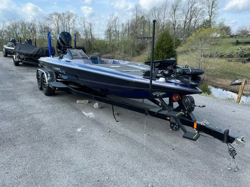 Slide: The Image of 2022 Bullet 21XRS boat on a trailer in a parking lot. - 6