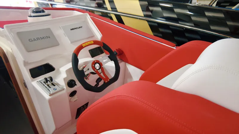 Slide: The Image of 2023 Cigarette 35 Cafe Racer boat interior with red and white seating and Garmin navigation. - 7