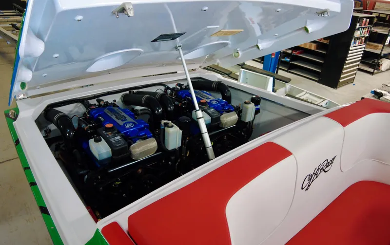 Slide: The Image of 2023 Cigarette 35 Cafe Racer boat engine compartment with dual engines and red-white seating. - 8