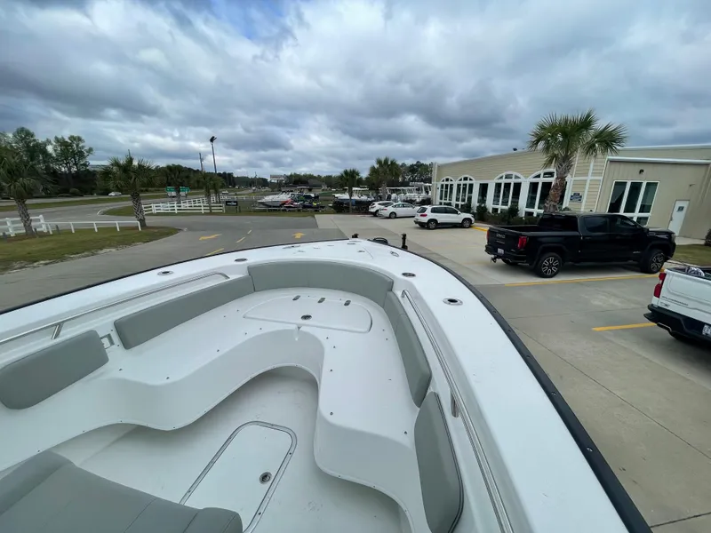 Slide: The Image of 2026 Cape Horn 24XS boat in parking lot, cloudy sky, palm trees, and vehicles in background. - 12