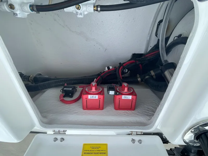 Slide: The Image of Battery compartment of 2026 Cape Horn 24XS boat with red batteries and wiring. - 17