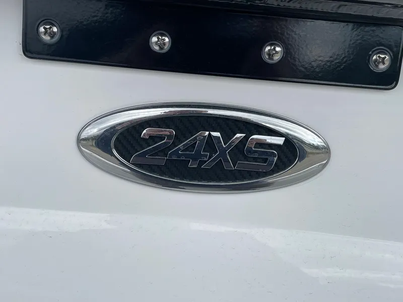 Slide: The Image of Cape Horn 24XS 2026 model emblem on a white surface with metallic finish. - 22