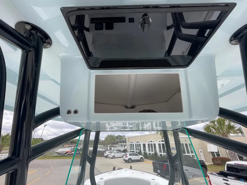 Slide: The Image of 2026 Cape Horn 24XS boat console with overhead storage and sleek design. - 10