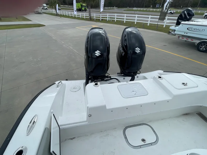 Slide: The Image of Cape Horn 24XS 2026 boat with dual Suzuki outboard motors, parked on a concrete surface. - 5