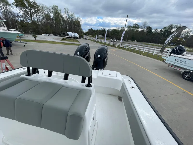 Slide: The Image of 2026 Cape Horn 24XS boat with dual engines, parked outdoors on a cloudy day. - 9