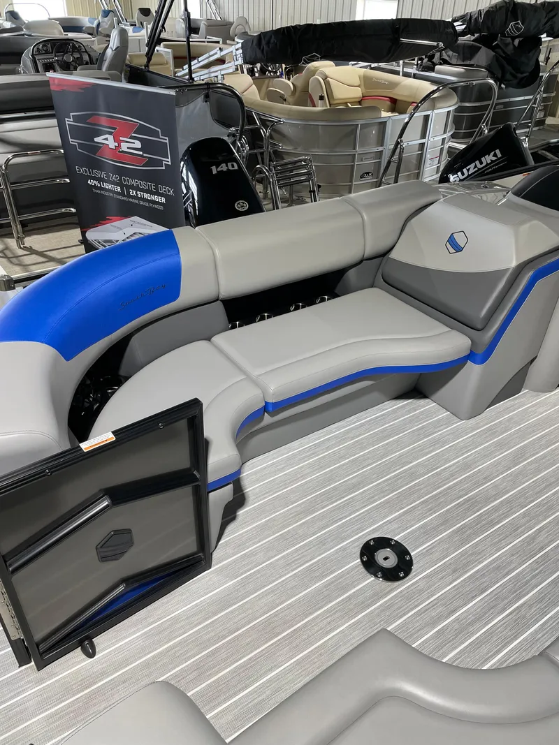 Slide: The Image of 2023 South Bay 525ARCH3.0 pontoon boat interior with gray and blue seating. - 10