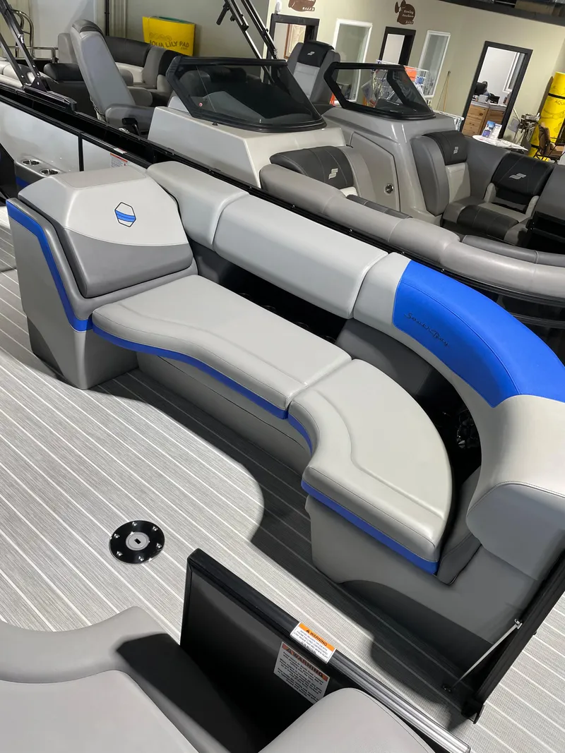 Slide: The Image of 2023 South Bay 525ARCH3.0 pontoon boat interior with gray and blue seating. - 11