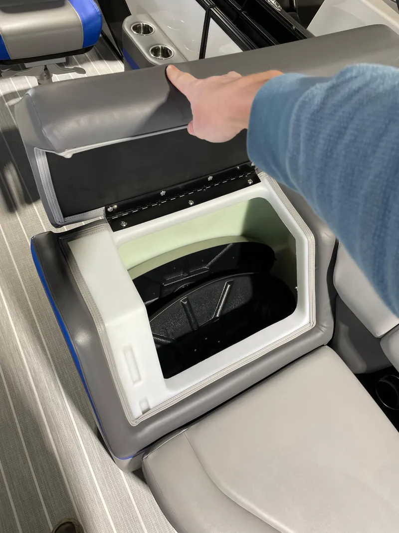 Slide: The Image of 2023 South Bay 525ARCH3.0 boat seat storage compartment being opened. - 12