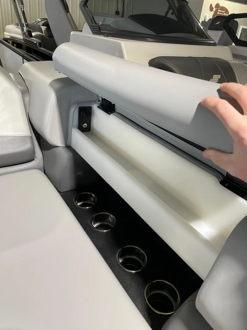 Slide: The Image of 2023 South Bay 525ARCH3.0 boat interior with storage compartment and cup holders. - 13