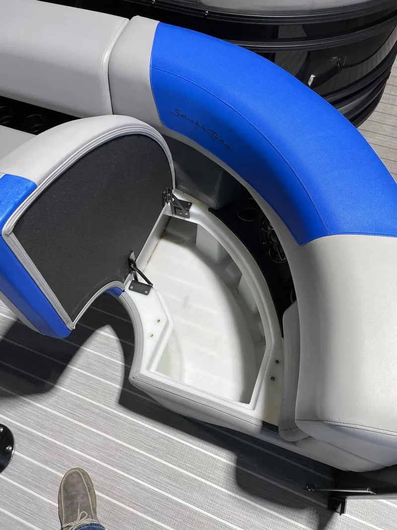 Slide: The Image of 2023 South Bay 525ARCH3.0 boat with open storage compartment and blue-gray seating. - 8