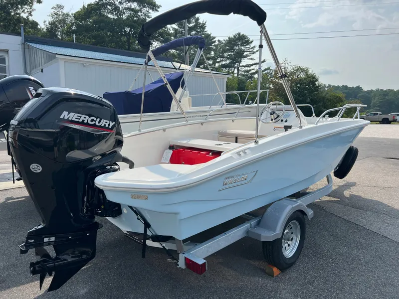 Slide: The Image of 2024 Boston Whaler 160 Super Sport boat on trailer with Mercury outboard motor. - 1