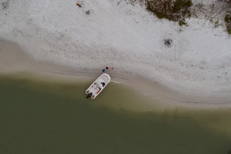 Slide: The Image of Aerial view of 2024 Boston Whaler 160 Super Sport on a sandy beach. - 14