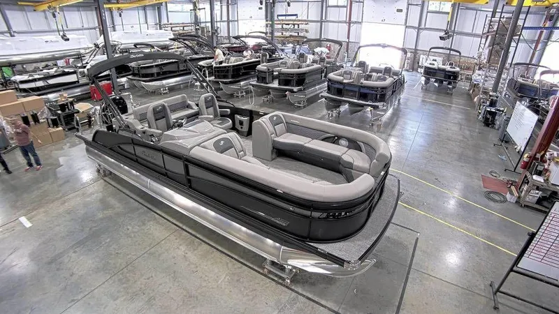 Slide: The Image of 2023 Barletta CORSA 25UC pontoon boat in a manufacturing facility. - 2