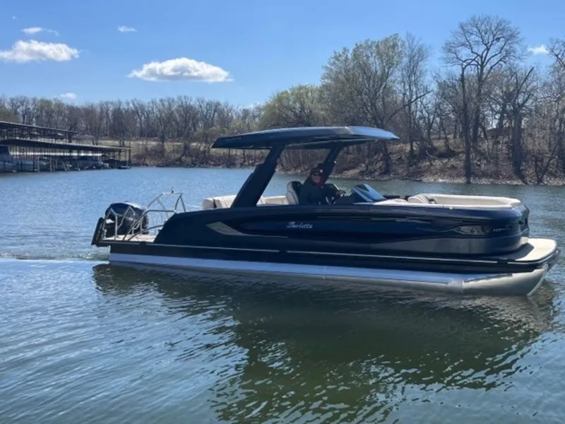 Slide: The Image of 2023 Barletta Reserve V26UC pontoon boat on a calm lake. - 1