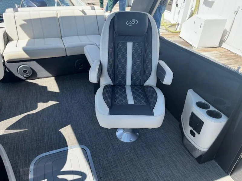 Slide: The Image of 2023 Barletta Reserve V26UC boat interior with luxury seating and cup holders. - 10