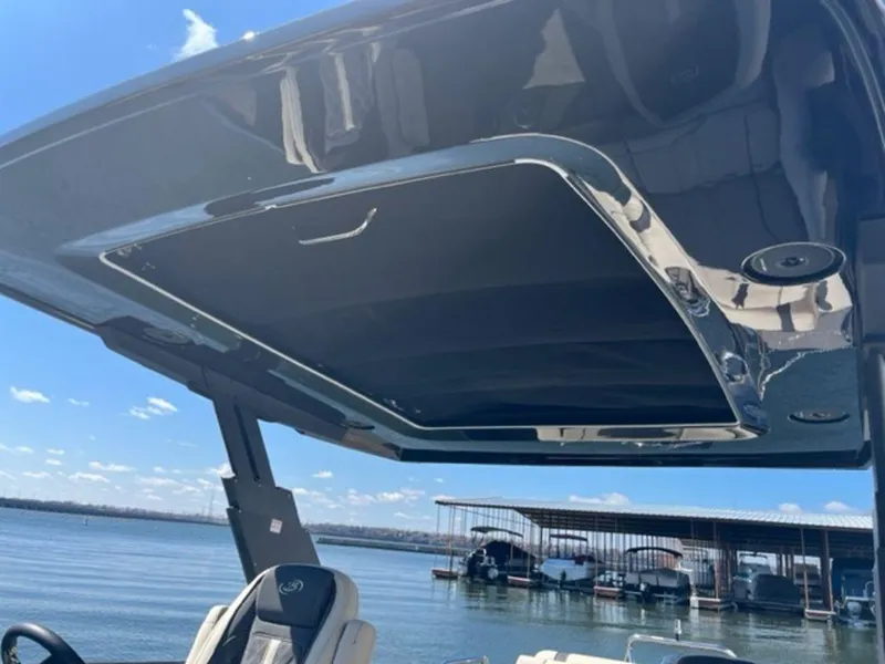 Slide: The Image of 2023 Barletta Reserve V26UC boat with sleek canopy design on a sunny day. - 11