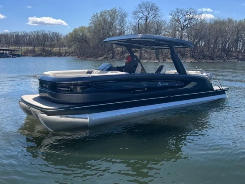 Slide: The Image of 2023 Barletta Reserve V26UC pontoon boat on a calm lake. - 12