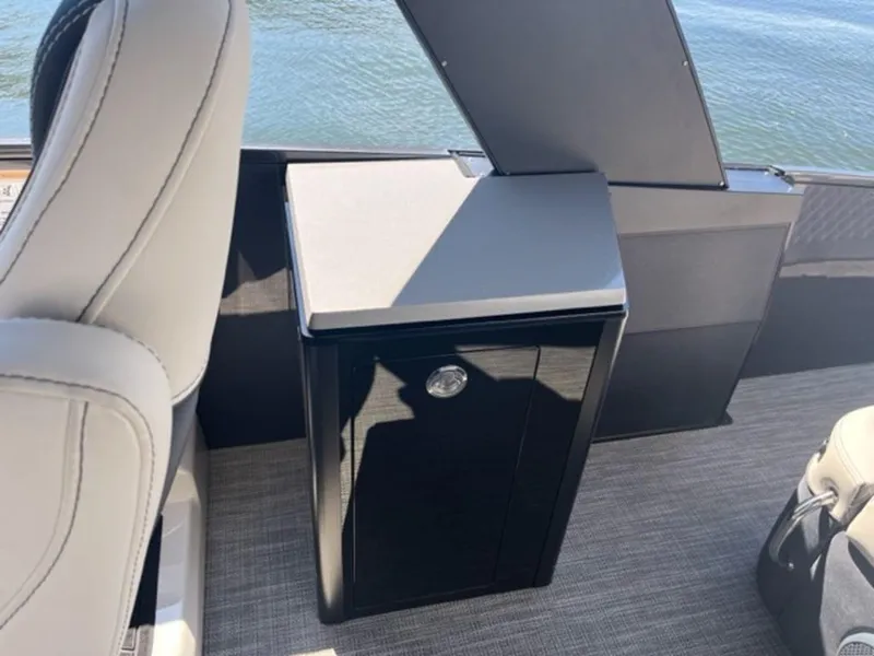 Slide: The Image of 2023 Barletta Reserve V26UC boat interior with sleek seating and storage unit. - 2