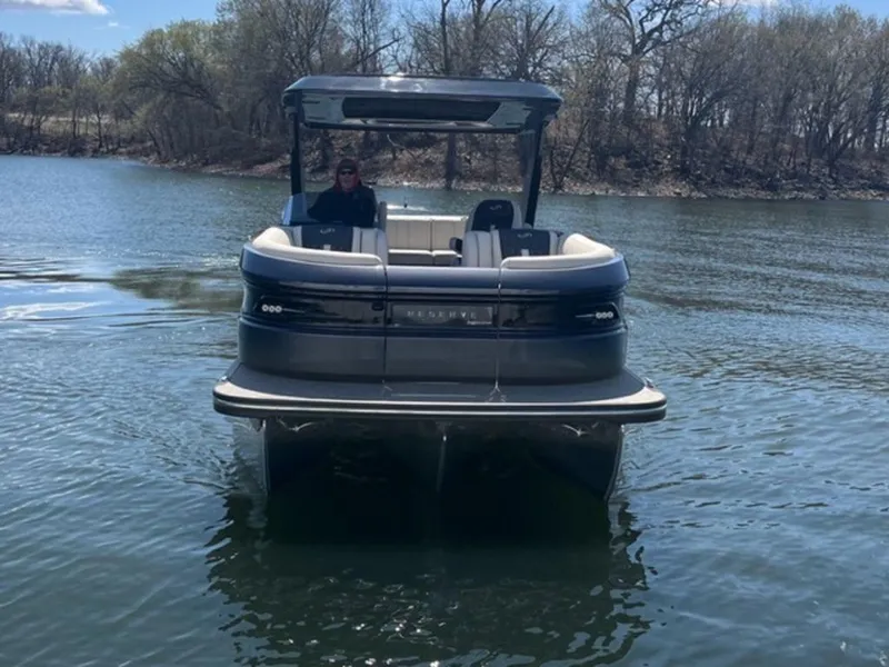 Slide: The Image of 2023 Barletta Reserve V26UC pontoon boat on a calm lake. - 3