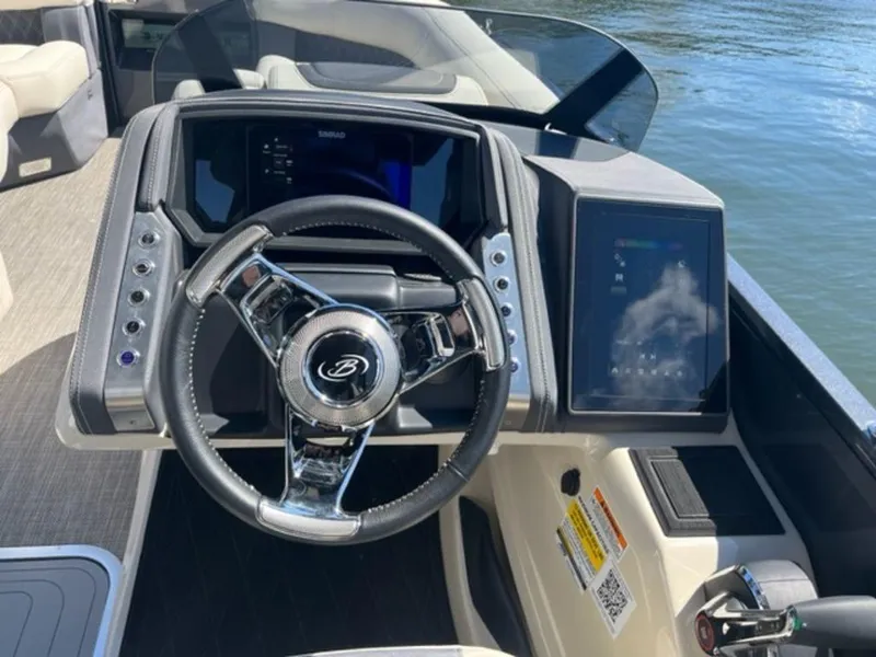 Slide: The Image of 2023 Barletta Reserve V26UC boat dashboard with modern steering and digital displays. - 5