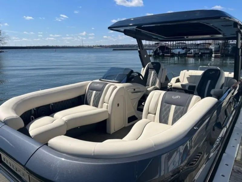 Slide: The Image of 2023 Barletta Reserve V26UC luxury pontoon boat on a serene lake. - 6