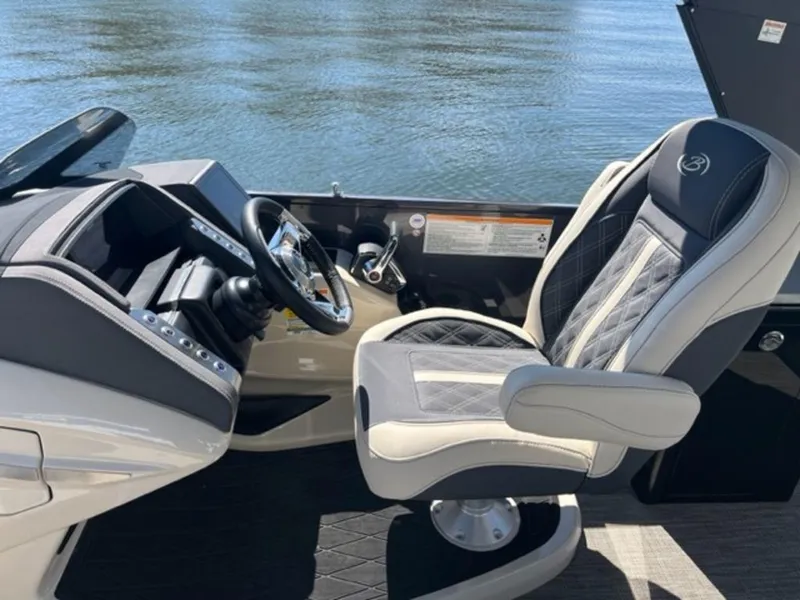Slide: The Image of 2023 Barletta Reserve V26UC boat interior with luxury captain's chair and control panel. - 7