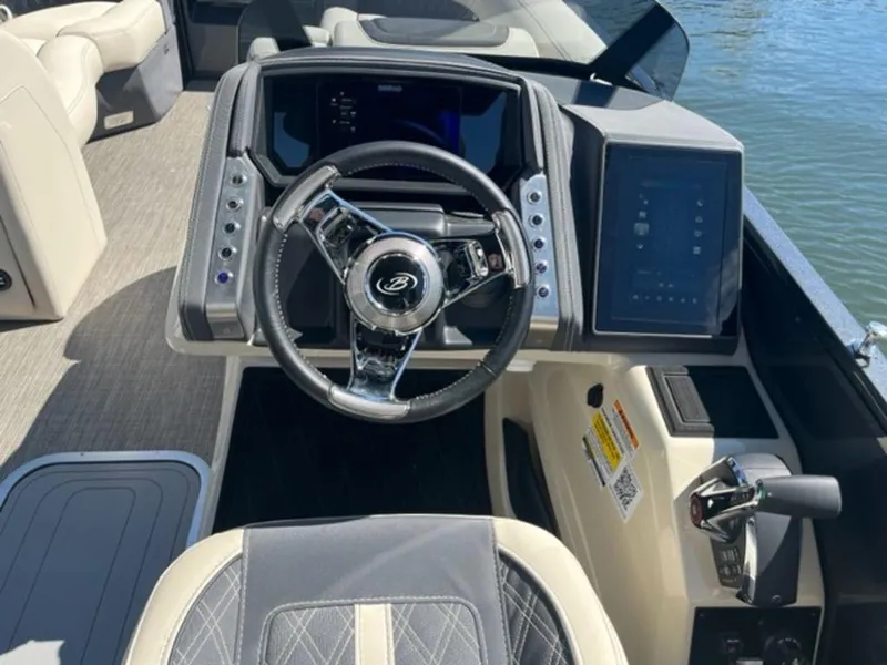 Slide: The Image of 2023 Barletta Reserve V26UC boat dashboard with steering wheel and digital display. - 9