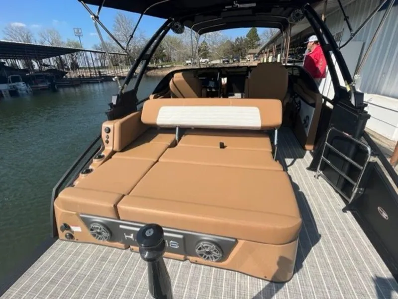 Slide: The Image of 2023 Harris Solstice DC 250 SLDH boat with spacious tan seating and modern design. - 12