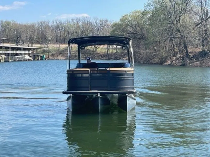 Slide: The Image of 2023 Harris Solstice DC 250 SLDH pontoon boat on a serene lake. - 3