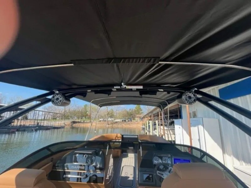 Slide: The Image of 2023 Harris Solstice DC 250 SLDH boat interior with canopy and dashboard view. - 5