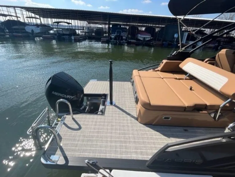 Slide: The Image of 2023 Harris Solstice DC 250 SLDH boat with Mercury engine at dock. - 6