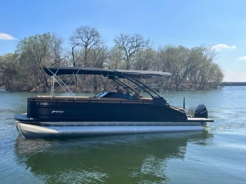 Slide: The Image of 2023 Harris Solstice DC 250 SLDH pontoon boat on a calm lake. - 7