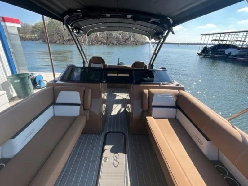 Slide: The Image of 2023 Harris Solstice DC 250 SLDH pontoon boat interior with tan seating on a sunny day. - 8