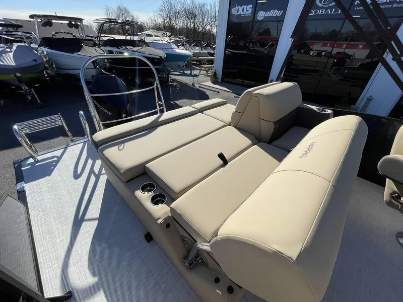 Slide: The Image of 2023 Harris Sunliner 250 boat with beige seating and sleek design. - 11