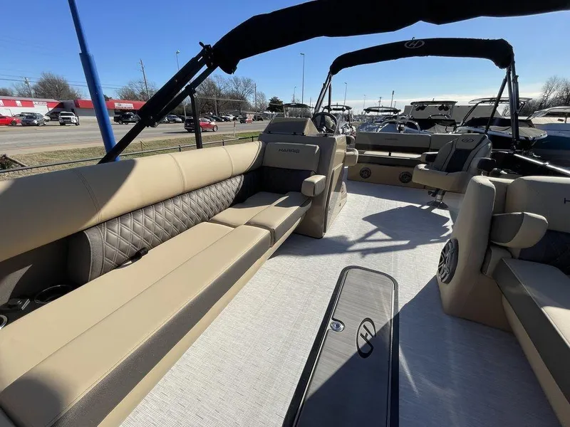 Slide: The Image of 2023 Harris Sunliner 250 pontoon boat interior with beige seating and modern design. - 12
