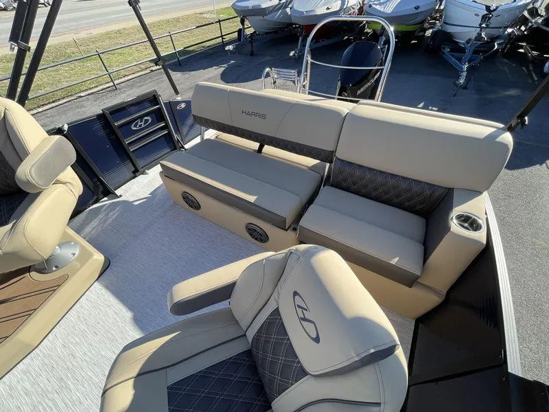 Slide: The Image of 2023 Harris Sunliner 250 boat interior with beige seating and modern design. - 14