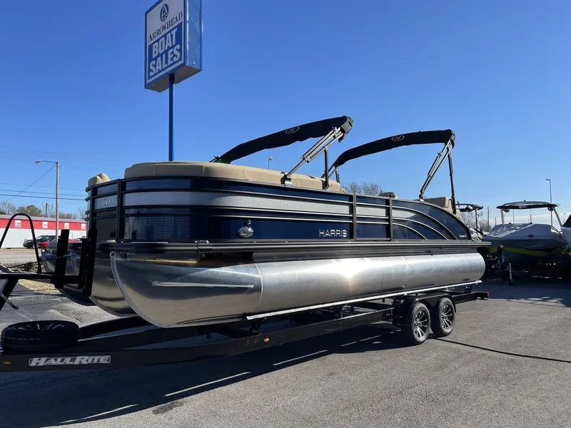 Slide: The Image of 2023 Harris Sunliner 250 pontoon boat on trailer at dealership. - 19
