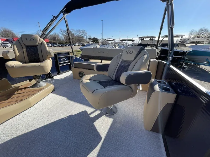 Slide: The Image of 2023 Harris Sunliner 250 boat interior with plush seating and cup holders. - 22
