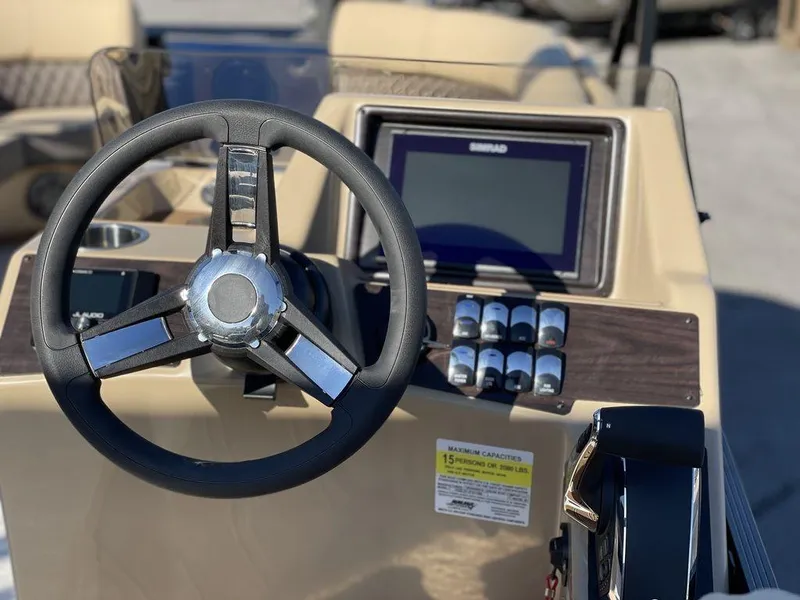 Slide: The Image of 2023 Harris Sunliner 250 boat dashboard with steering wheel and control panel. - 23