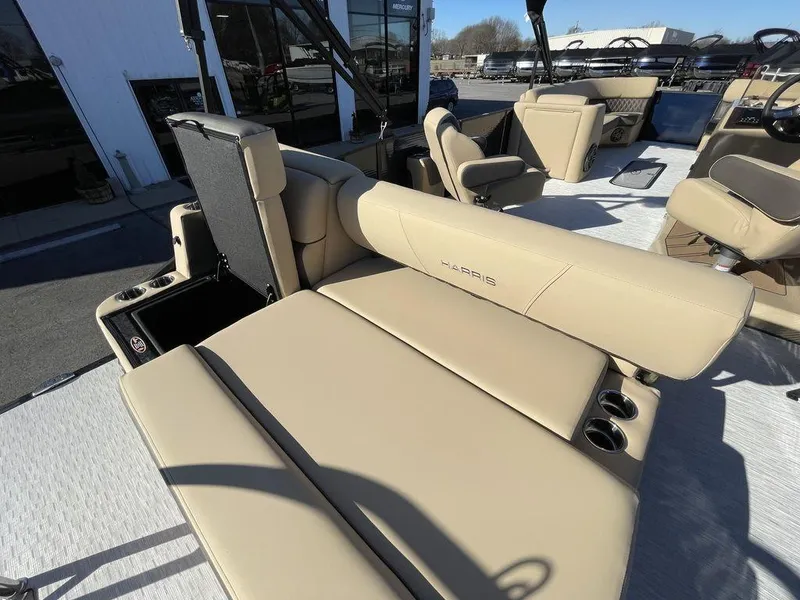 Slide: The Image of 2023 Harris Sunliner 250 boat interior with beige seating and cup holders. - 24