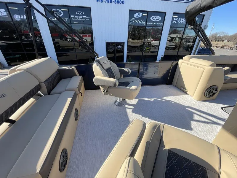 Slide: The Image of 2023 Harris Sunliner 250 boat interior with beige seating and modern design. - 25