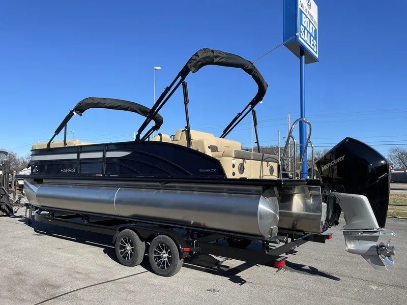 Slide: The Image of 2023 Harris Sunliner 250 pontoon boat on trailer, displayed outdoors. - 28